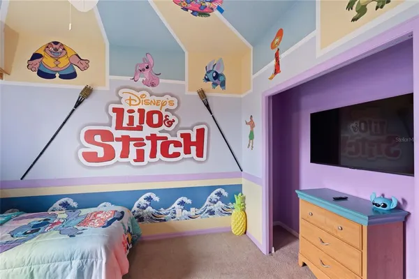 a utility room with a bed a couch and dresser