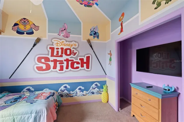 a utility room with a bed a couch and dresser