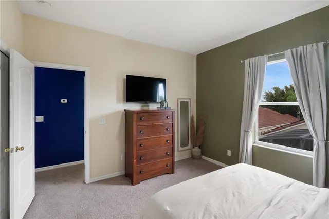 a bedroom with a bed and a television in it