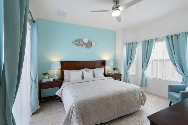 a bedroom with a bed and a large window