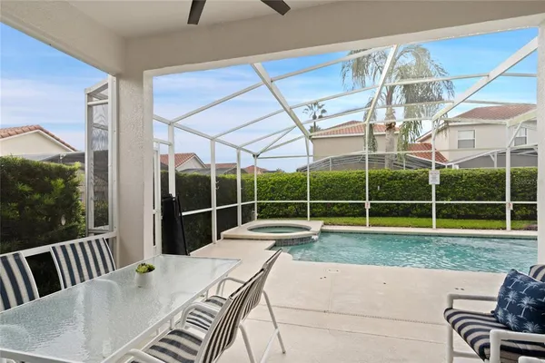 a view of swimming pool with outdoor seating and kitchen view