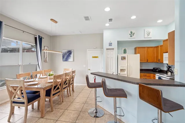 a dining room with furniture and wooden floor