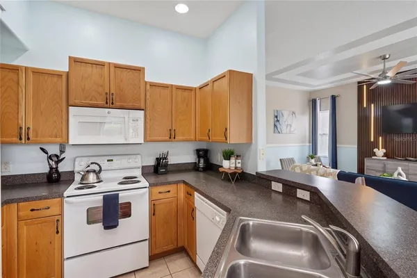 a kitchen that has a sink and a stove in it