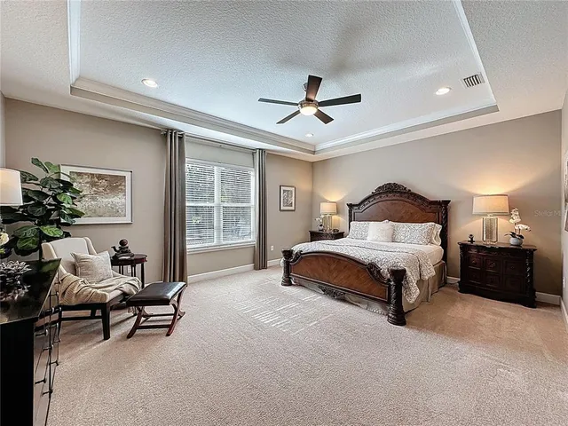 a bedroom with a bed a night stand and a window