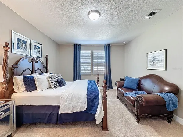 a spacious bathroom with a granite countertop sink mirror and a toilet