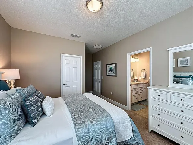 a view of a dining room with furniture and a mirror