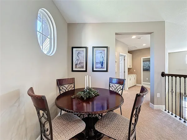a view of a hallway with wooden floor and stairs