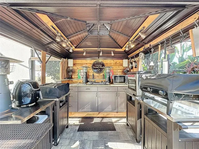 a backyard of a house with table and chairs