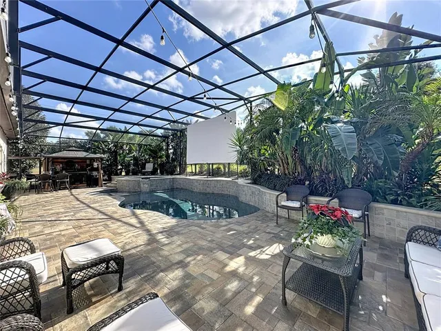 a view of a lake with couches in the patio