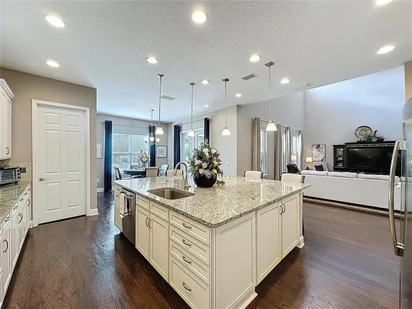 a kitchen with kitchen island and white cabinets