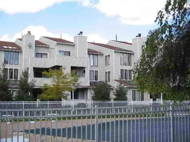 a front view of a house with a fence