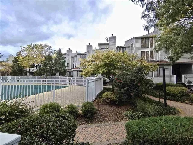 a view of a garden with wooden fence