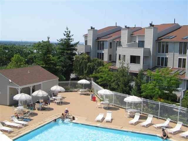 700 Mainsail Lane, Unit 700 Secaucus, NJ 07094 - Photo 28 of 28 a view of a patio with table and chairs potted plants and large trees