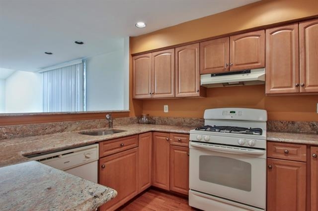 700 Mainsail Lane, Unit 700 Secaucus, NJ 07094 - Photo 6 of 28 a kitchen with stainless steel appliances granite countertop a sink stove and cabinets