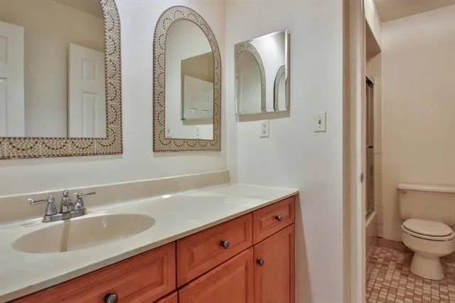 a bathroom with 2 sink and a mirror