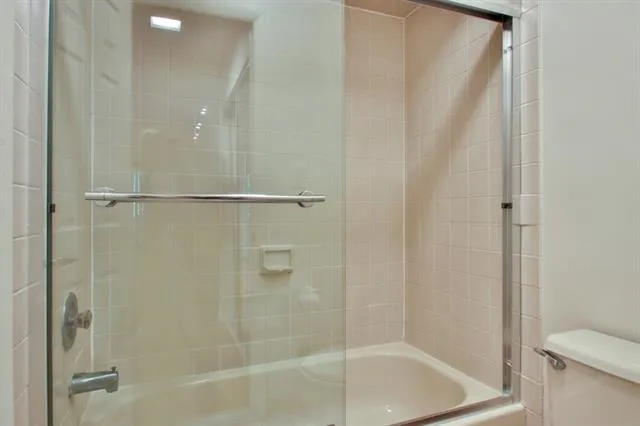 a bathroom with a shower and a toilet