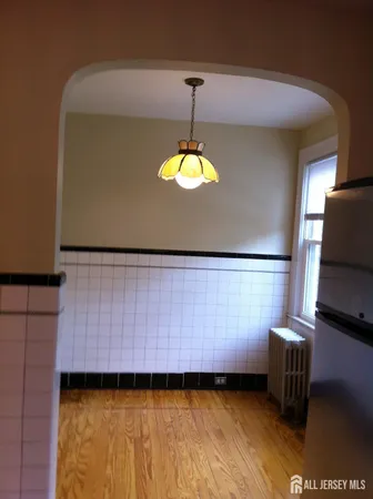 a view of a room with wooden floor and window