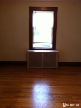 a room with wooden floor and a window