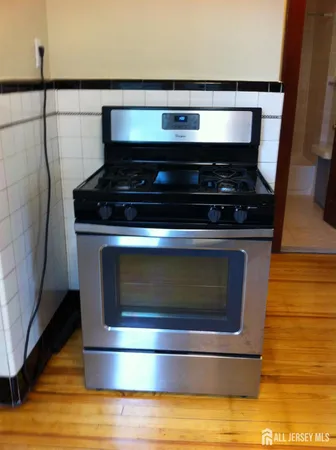 a stove top oven sitting inside of a kitchen