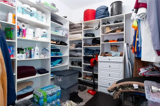 a bedroom with a bed and a ceiling fan