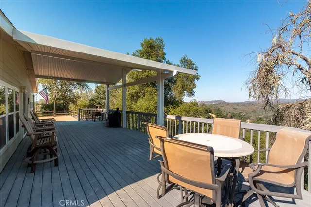 a view of a patio with a table and chairs under an umbrella