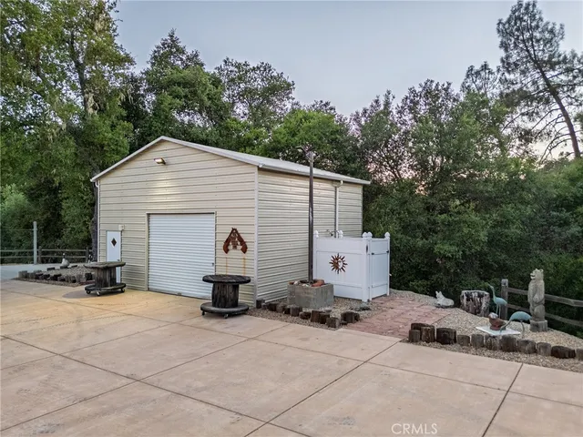 a backyard of a house with table and chairs