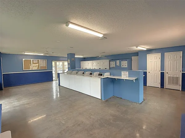 a large white kitchen with lots of counter space white cabinets and stainless steel appliances