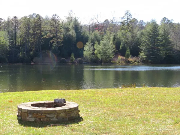 a view of a lake with a yard and a trees
