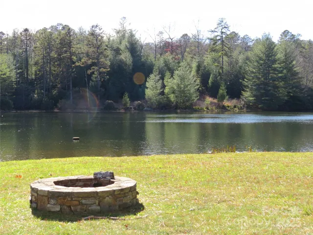 a view of a lake with a yard and a trees