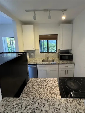 a kitchen with a stove and a sink