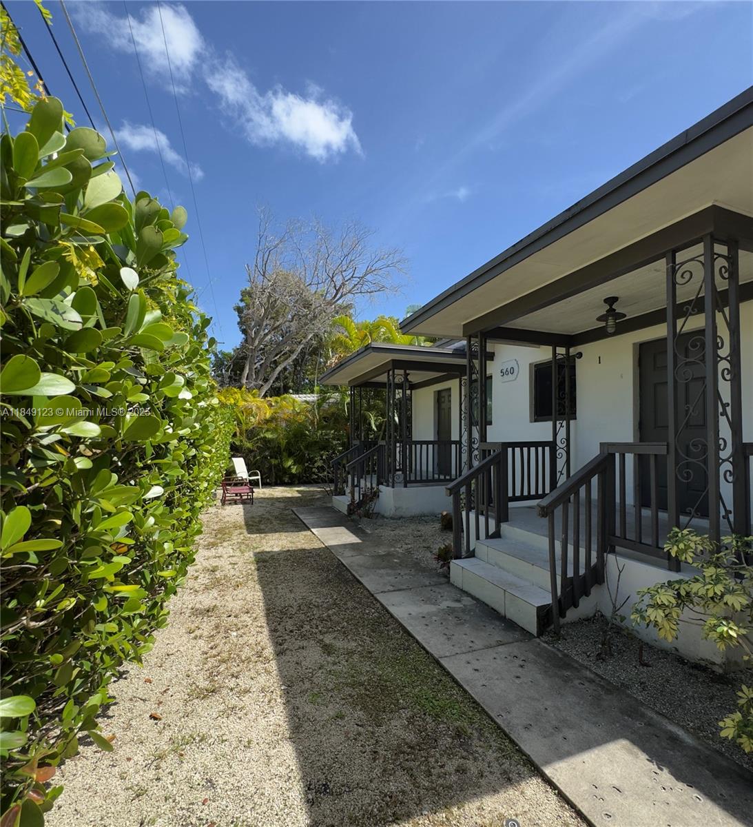 560 Northeast 69th Street, Unit 1 Miami, FL 33138 - Photo 4 of 23 a view of a porch with chairs and potted plants