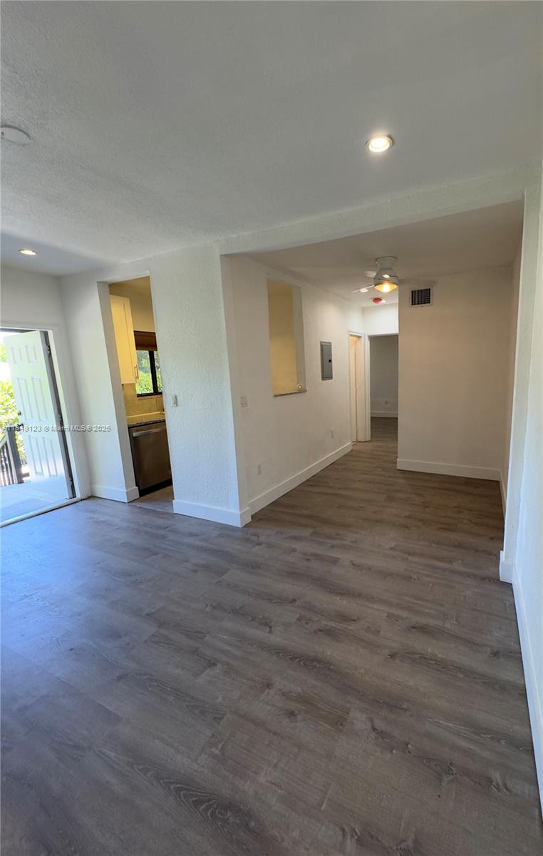 560 Northeast 69th Street, Unit 1 Miami, FL 33138 - Photo 8 of 23 an empty room with wooden floor and windows