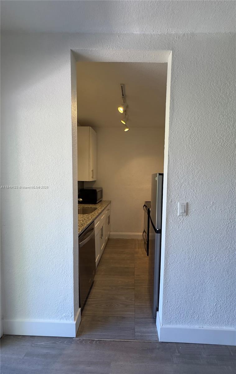 560 Northeast 69th Street, Unit 1 Miami, FL 33138 - Photo 10 of 23 a kitchen with a refrigerator and a stove