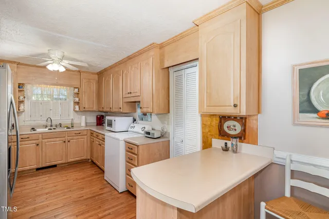 a kitchen with a stove a sink and a refrigerator