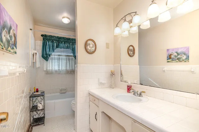 a bathroom with a sink a vanity and a mirror