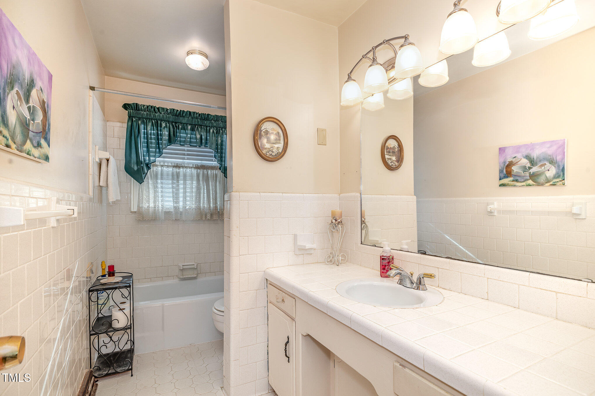 1108 Friendly Road Dunn, NC 28334 - Photo 13 of 17 a bathroom with a sink a vanity and a mirror