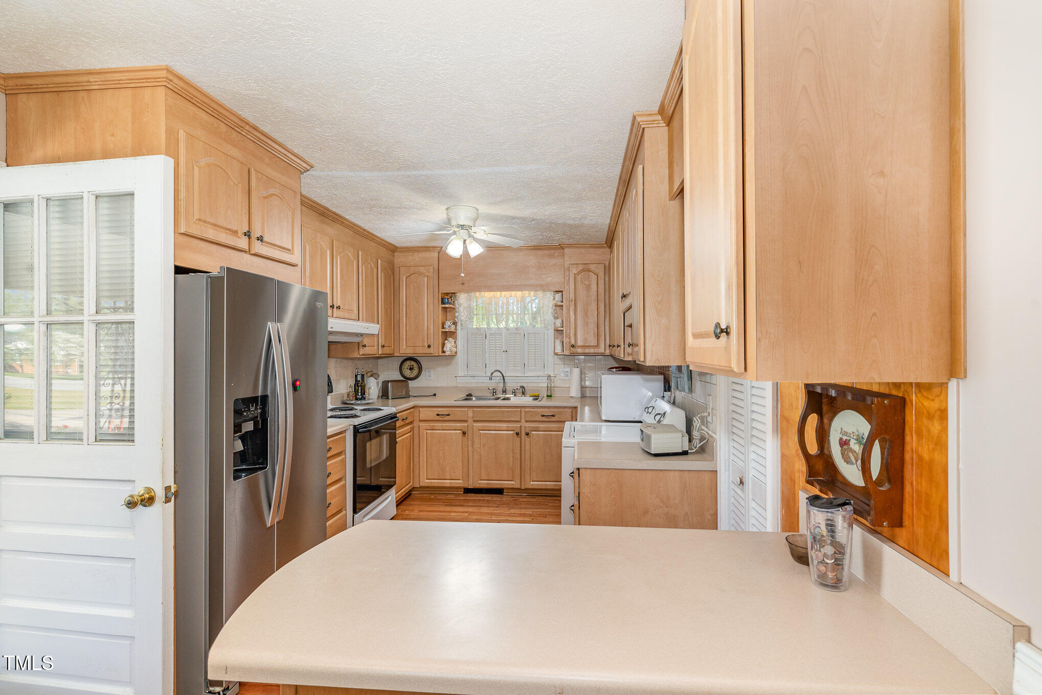 1108 Friendly Road Dunn, NC 28334 - Photo 4 of 17 a kitchen with a refrigerator and a stove