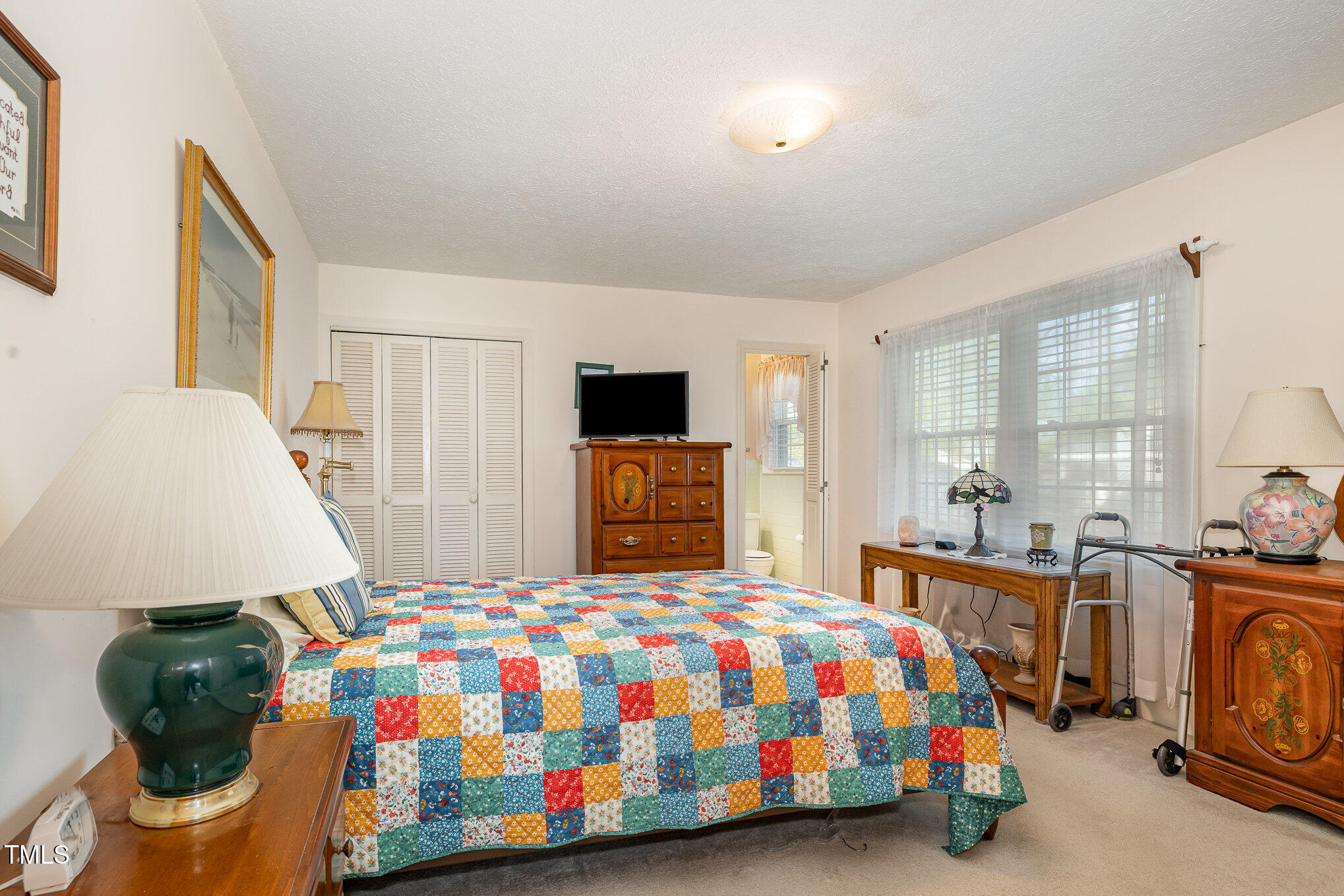 1108 Friendly Road Dunn, NC 28334 - Photo 9 of 17 a bedroom with a bed and a table in it