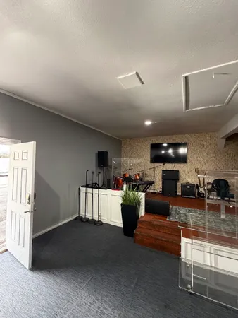 a living room with fireplace furniture and a ceiling fan