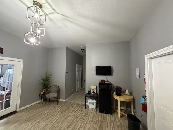 a view of a livingroom with furniture and a workspace