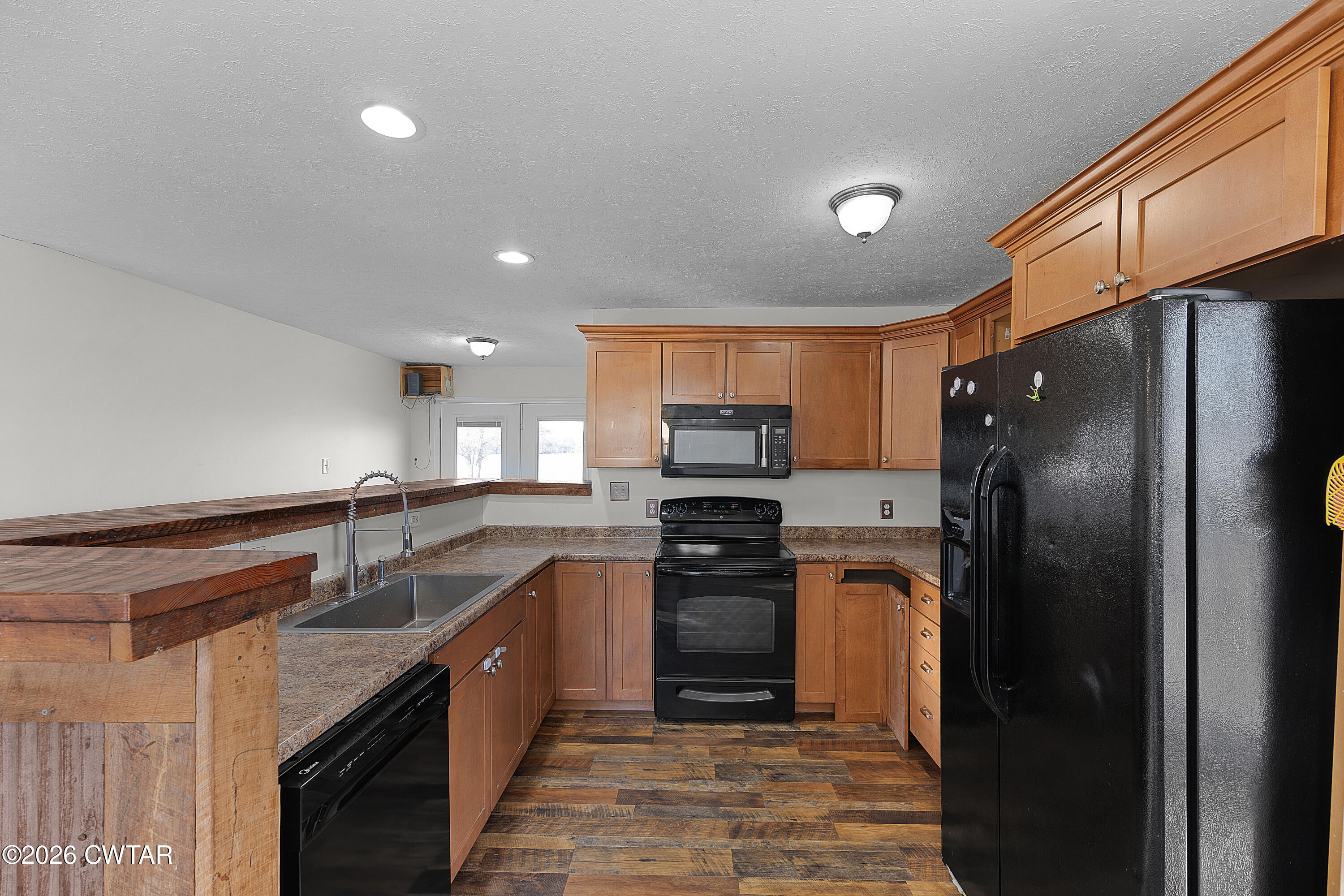 244 Loop Road Trenton, TN 38382 - Photo 11 of 25 a kitchen with stainless steel appliances granite countertop a sink stove and refrigerator
