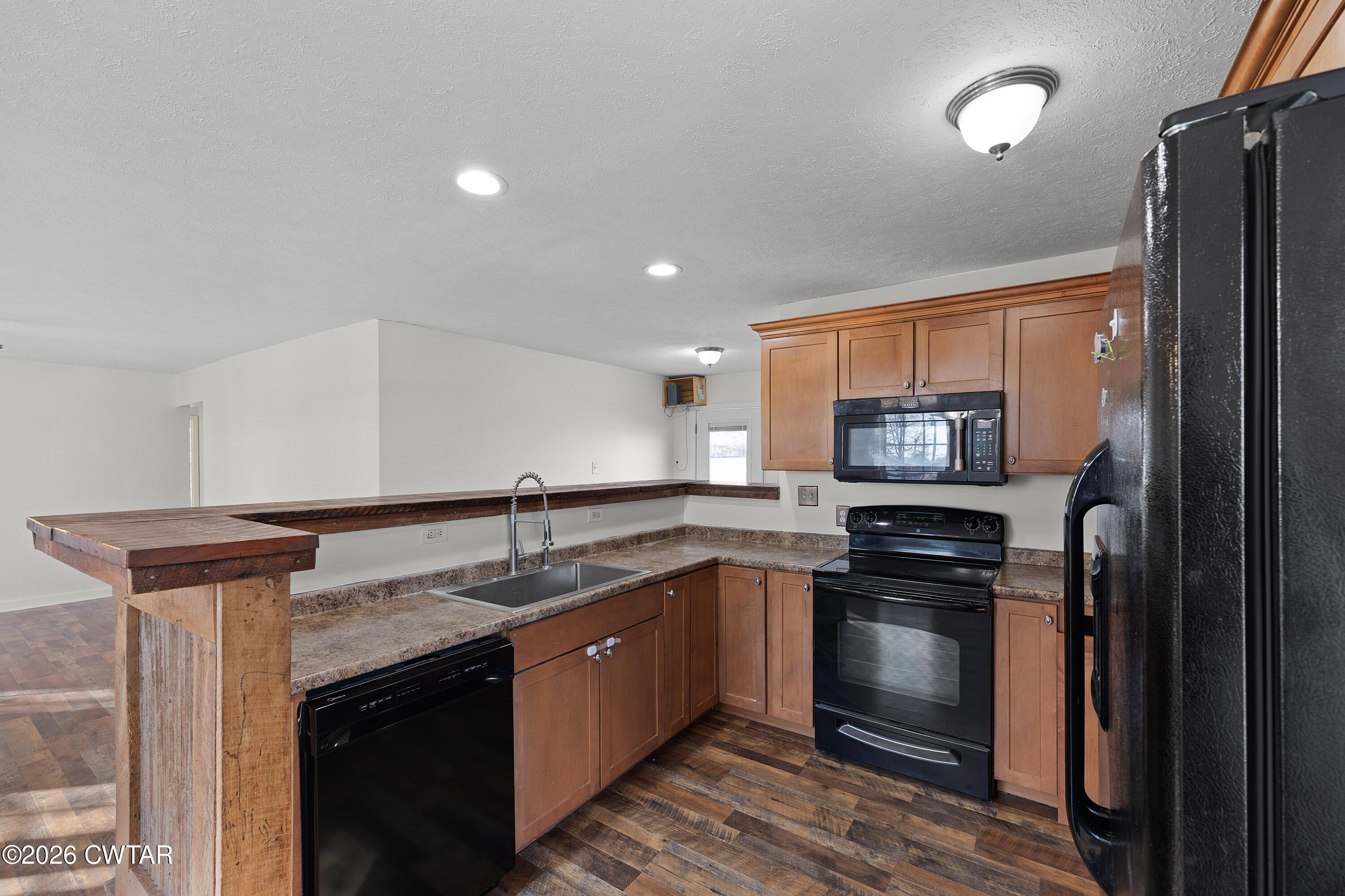 244 Loop Road Trenton, TN 38382 - Photo 12 of 25 a kitchen with stainless steel appliances granite countertop a sink stove and refrigerator