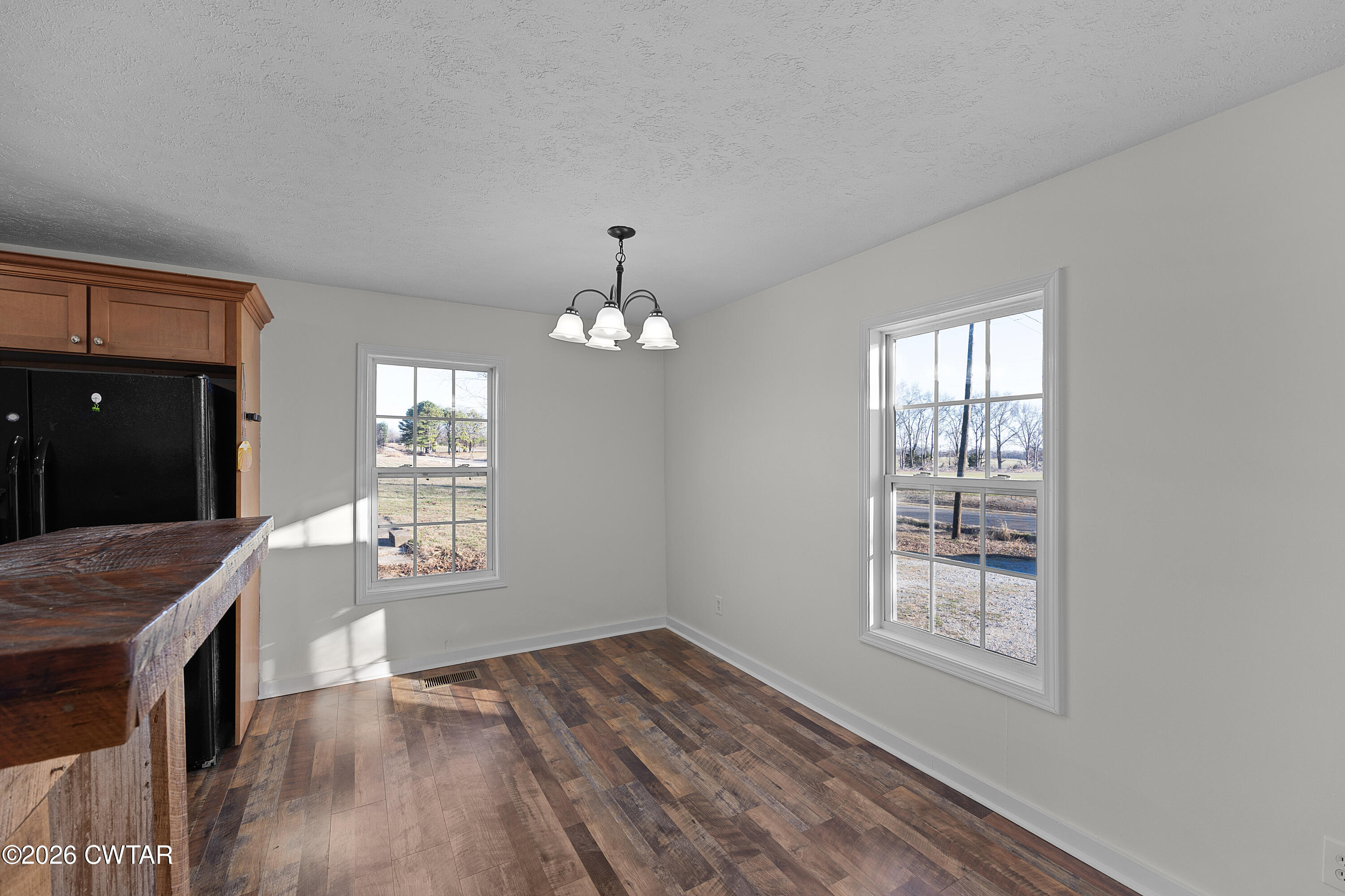 244 Loop Road Trenton, TN 38382 - Photo 13 of 25 a view of an empty room with a window and wooden floor