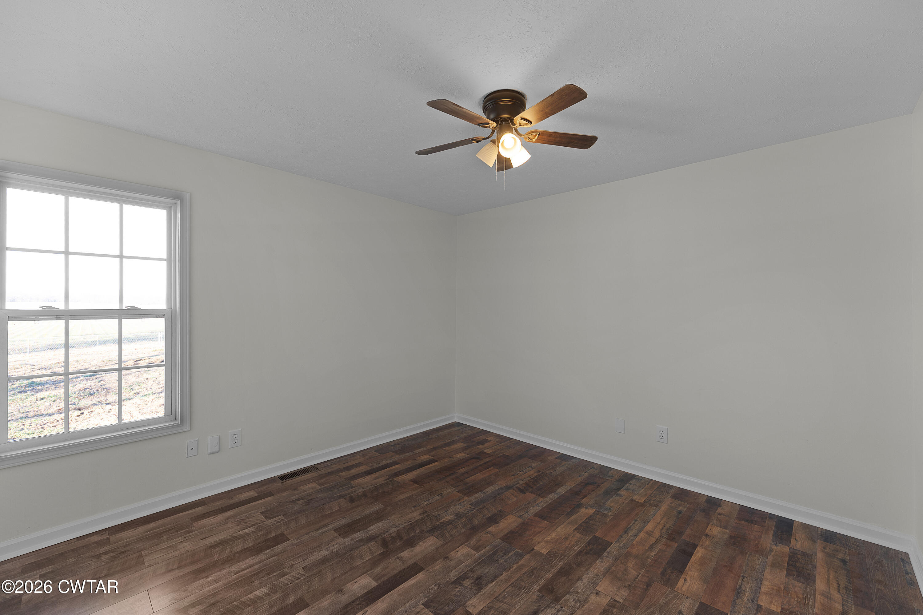 244 Loop Road Trenton, TN 38382 - Photo 19 of 25 wooden floor in an empty room with a window