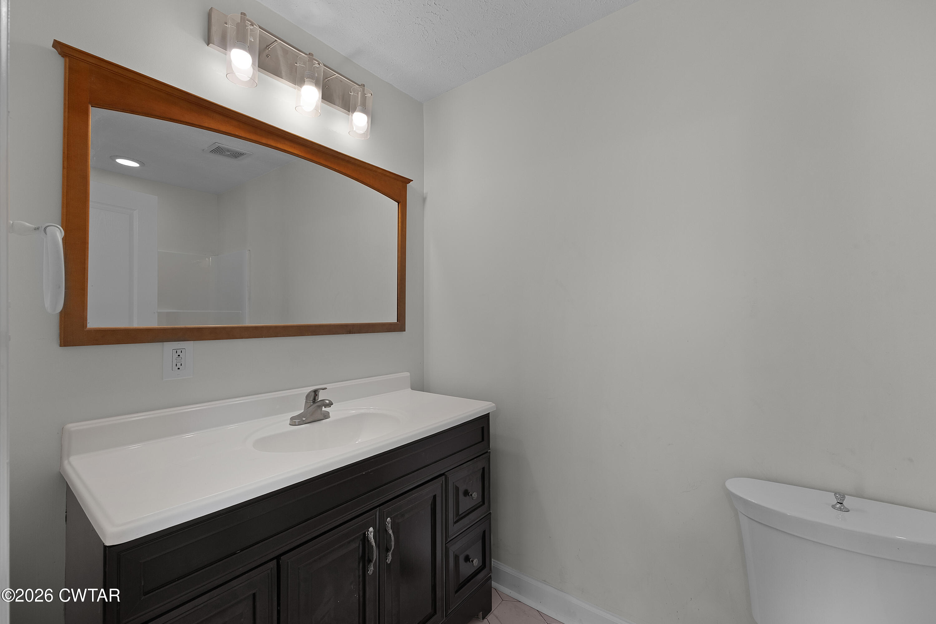 244 Loop Road Trenton, TN 38382 - Photo 23 of 25 a bathroom with a sink vanity and a mirror