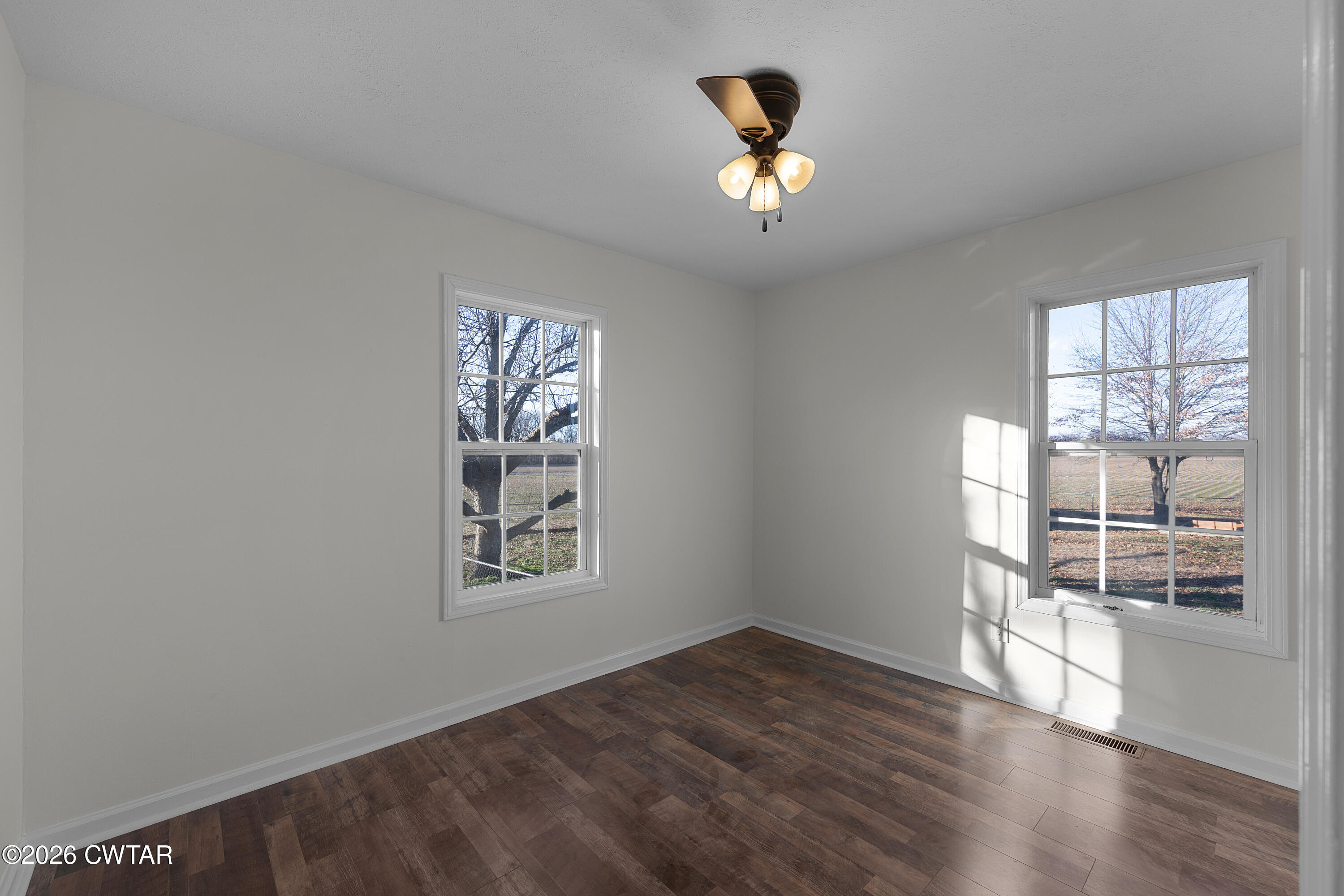 244 Loop Road Trenton, TN 38382 - Photo 24 of 25 an empty room with wooden floor fan and windows
