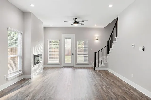 wooden floor in an empty room with a window and wooden floor