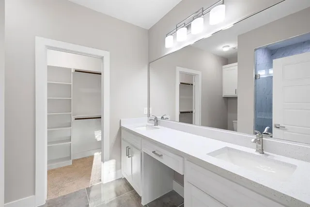 a bathroom with a sink double vanity and a mirror