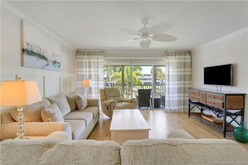 1852 Southwest Palm City Road, Unit 201 Stuart, FL 34994 - Photo 5 of 34 a living room with furniture and a flat screen tv