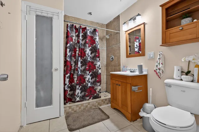a bathroom with a toilet a sink and a shower